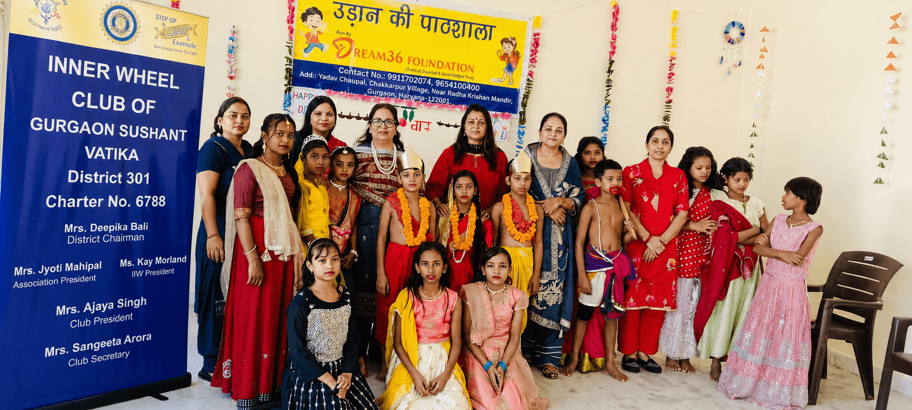Children in costume with volunteers at a Dream36 Foundation festival day